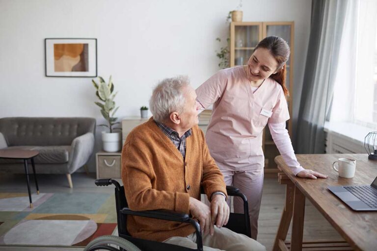 Older adult in an assisted living room using a tablet beside a printed instruction guide